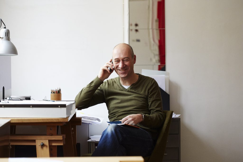 Mature man on the phone in creative studio